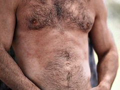 Solo hairy jock with athletic body jerks his cock after casting