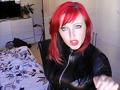 ginger-haired smoking in leather catsuit