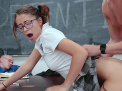 Two randy teenagers are banging in front of their teacher