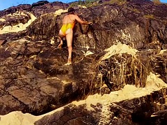 Walks on the beach and in the mountains with an orange one-piece swimsuit