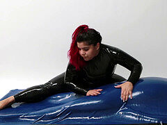 dominatrix wearing latex tormenting trapped Slave in Rubber Vacuum Bed VacBed