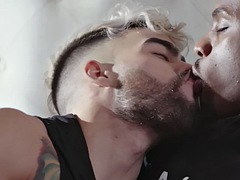 Black gay fucks a white stud in the ass while making out