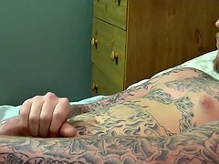 Tattooed amateur jerks off his erect, lubed cock and cums