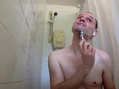 A man washes himself in the shower and then shaves his body, balls, armpits, legs and anus