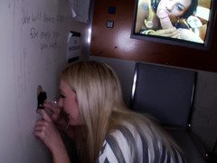 Blonde teases a cock through a glory hole with her tongue and cunt