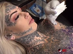 Sascha plays with Amber Luke while she gets tattooed