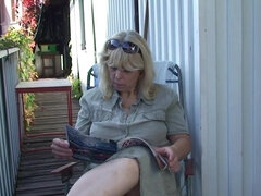 The blonde granny relaxing on the porch and gives a blowjob
