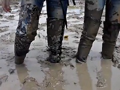 Two Thai men in high boots swim in the mud!