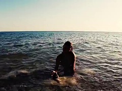 Traveling slut teases a videographer and fucks him on the beach