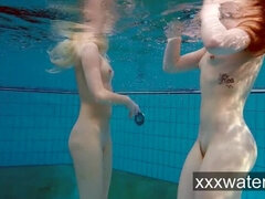 Milana and Katrin strip eachother underwater