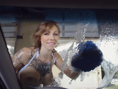 Huge breasted woman is washing the car with her large boobs