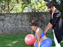 Yoga instructor helping his yoga student