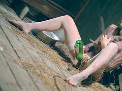 doll is shackled in a dirty basement jacking with a bottle