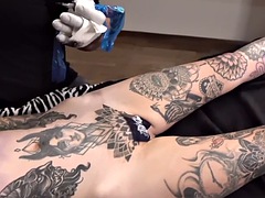 Sascha plays with Amber Luke while she gets a tattoo