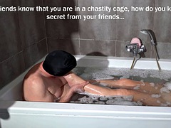 In the bathroom, my submissive in a chastity cage takes care of my feet