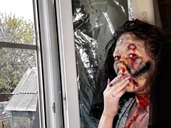 Wife smokes a cigarette makeup zombie