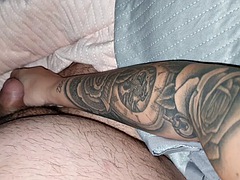 Tattooed stepmom jerks off stepsons cock, making him feel like a king