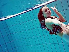 Nina, a pretty young girl with a hairy pussy, in the pool.