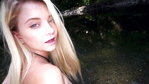 Delightful blonde gives a guy with camera blowjob at a riverbank