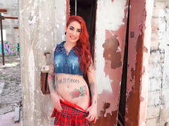 Redhead is having some sex while outside in a ruin