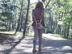 Handcuffed girl walks in the forest with the vibrator inside her diaper