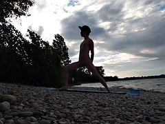 Slim nudist boy doing yoga naked on a nudist beach. Nude yoga video by John Artin, gay porn model, skinny naturist, twink, practice