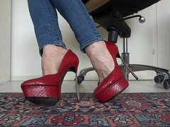 Red platform designer high heels with extreme metal heels in close-ups