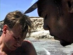 A hot German woman receives a double penetration on the beach