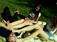 Two barefoot girls in park having their feet worshiped by a stranger (foot worship, public feet)