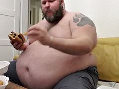 Superchubby SOC - fat guy eating a big burger and onion rings