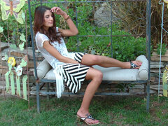 Sexy August Ames with fake tits fucks herself solo in the garden