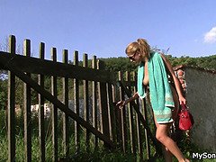 Old man toying teen girl outdoors