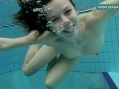 Podvodkova swimming in blue bikini in the pool