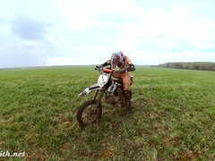 Naked woman riding a Dirt Bike