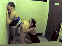 Two women are showing each other love in the bathroom in a restaurant