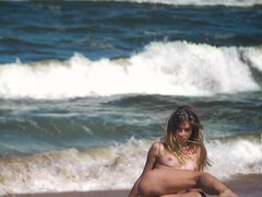 Charming and young Natalia E has fun on the beach