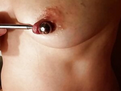 nippleringlover excited milf inserting 16mm metal beads in extreme stretched nipple piercings