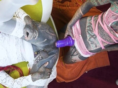 Tattooed trans sissy gets ass fucked with a strap-on