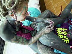 Alternative punk femdom squirts while stretching her ass with toys and propping it up with a dildo