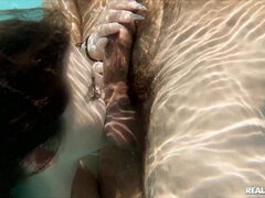 Three lovers relax in the pool by playing orgy games