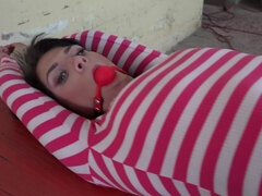 Lovely girl Sarah Simons is being tied up and ball-gagged