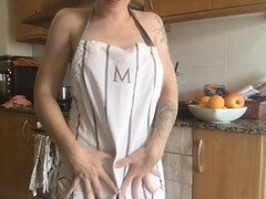 Seductive redhead cooks in nothing but an apron, dancing to drive you wild