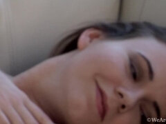 Camille undresses on white sofa to show hairy body