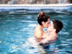 A couple is in the pool, doing amazing stuff with each other there