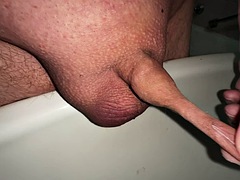 Plays with the foreskin of my micro cock while urinating