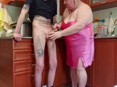 Kitchen buddy takes a deep throat and gives a handjob while enjoying the load