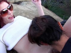 A redhead is getting licked and fucked on the rocks here