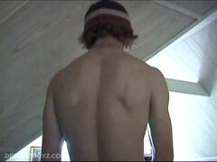 Adam relaxes on the floor watching porn video, strokes cock, plays with butthole, and blasts cum load onto skateboard