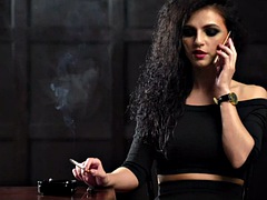 Curly-haired smoker talks on the phone