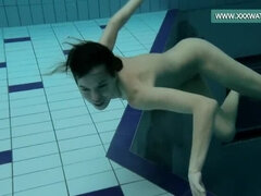 Podvodkova swimming in blue bikini in the pool